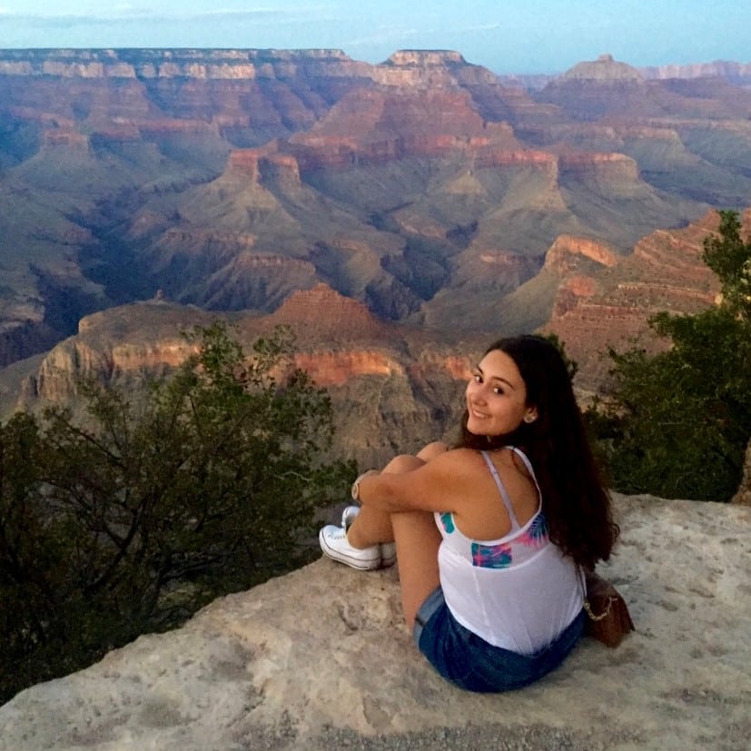 Daniela Osorio sitting on edge of mountain