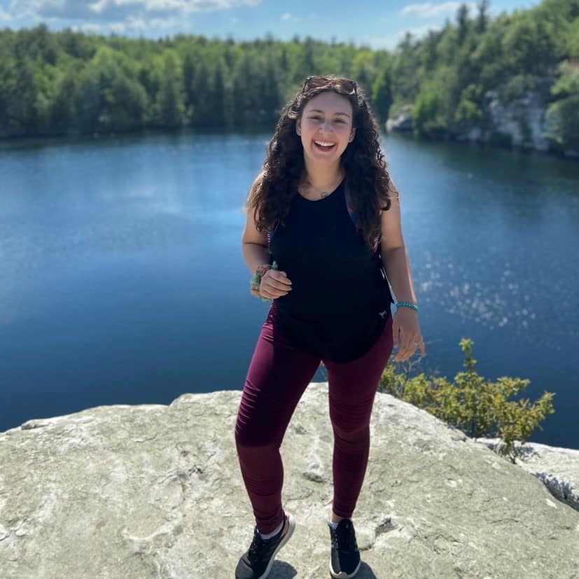 Daniela Osorio on a rock near body of water