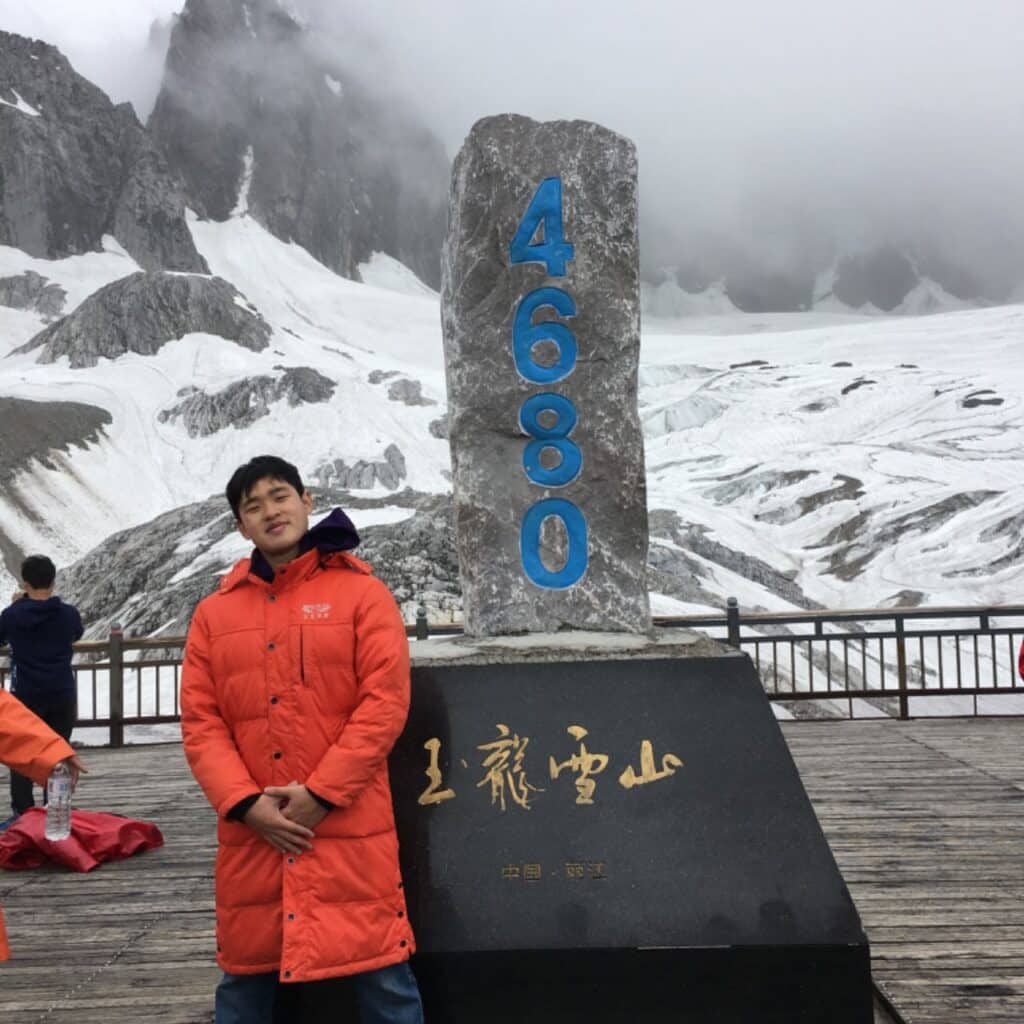 David Jiang at the top of a montain