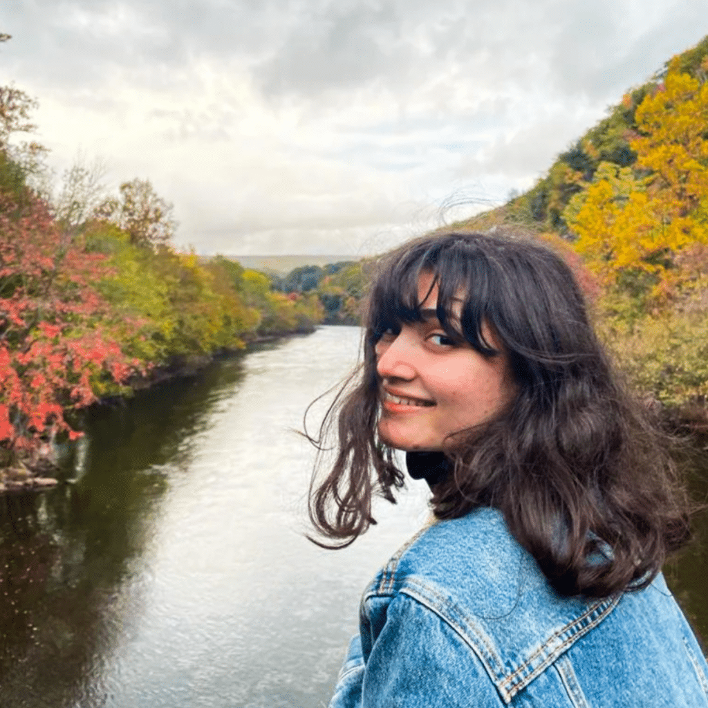 Sejal Kadam portrait in front of river in autumn