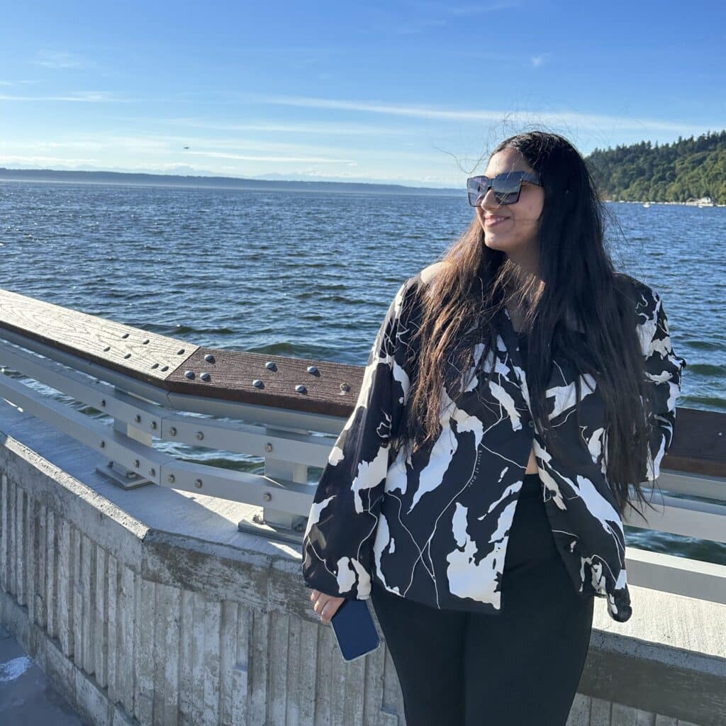 Eisha Joshi leaning by a pier