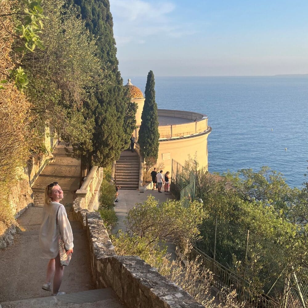 Emily Loftus walking down steps near the ocean