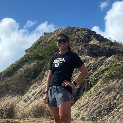 Emma Burnett standing in front of a mountain