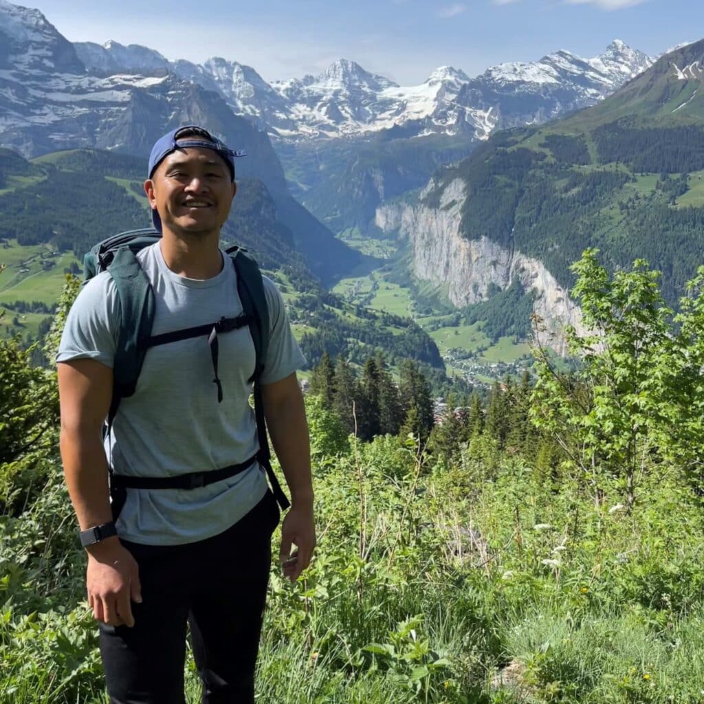 George Hsieh hiking standing in front of Lauterbrunnen valley, Switzerland