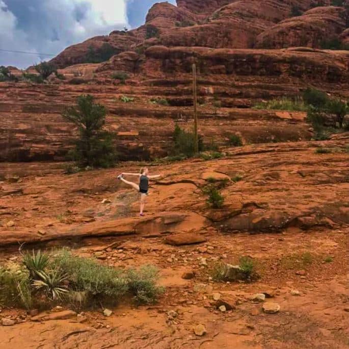 Melissa Wint doing a yoga pose on a desert rock