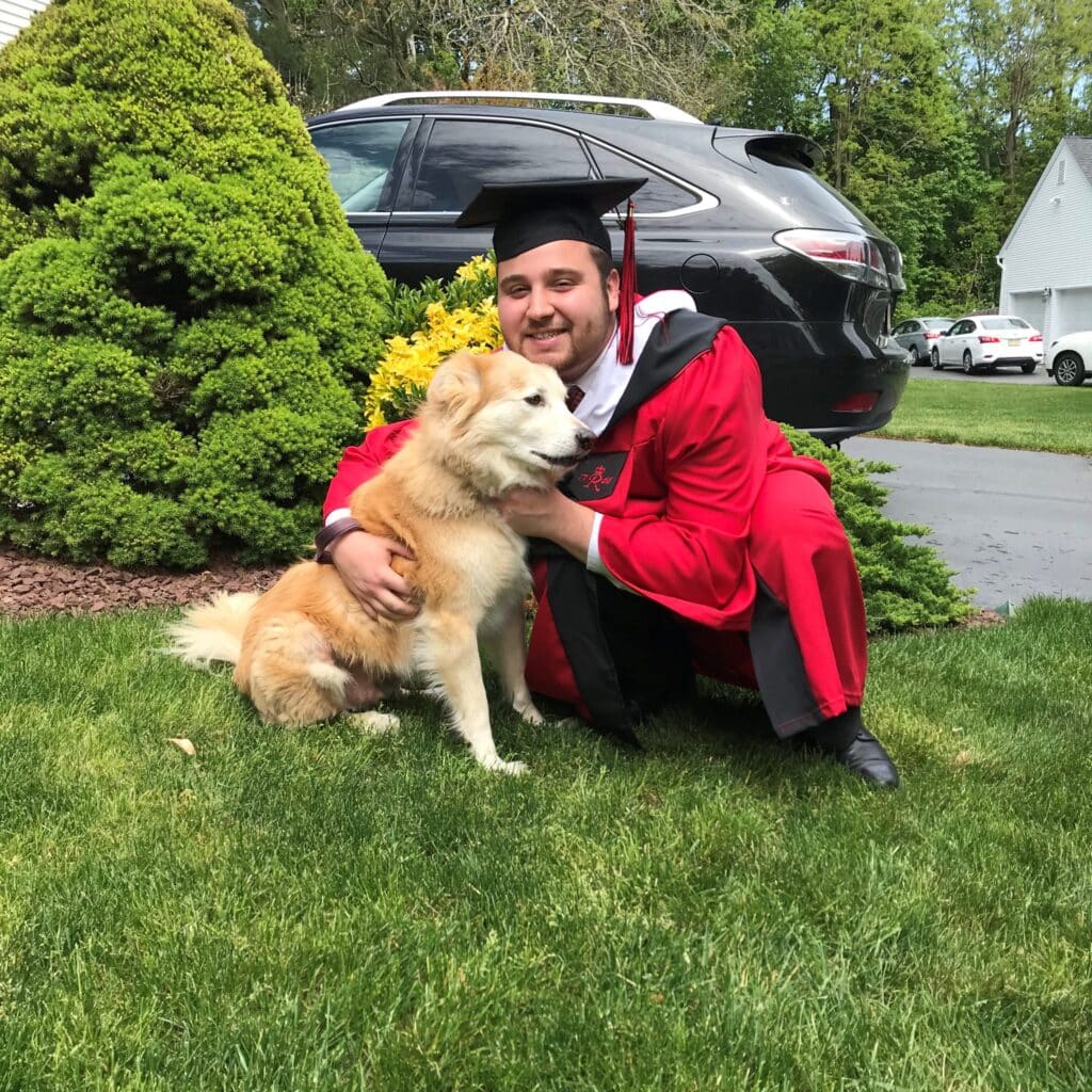 James Lenzi with dog on graduation day