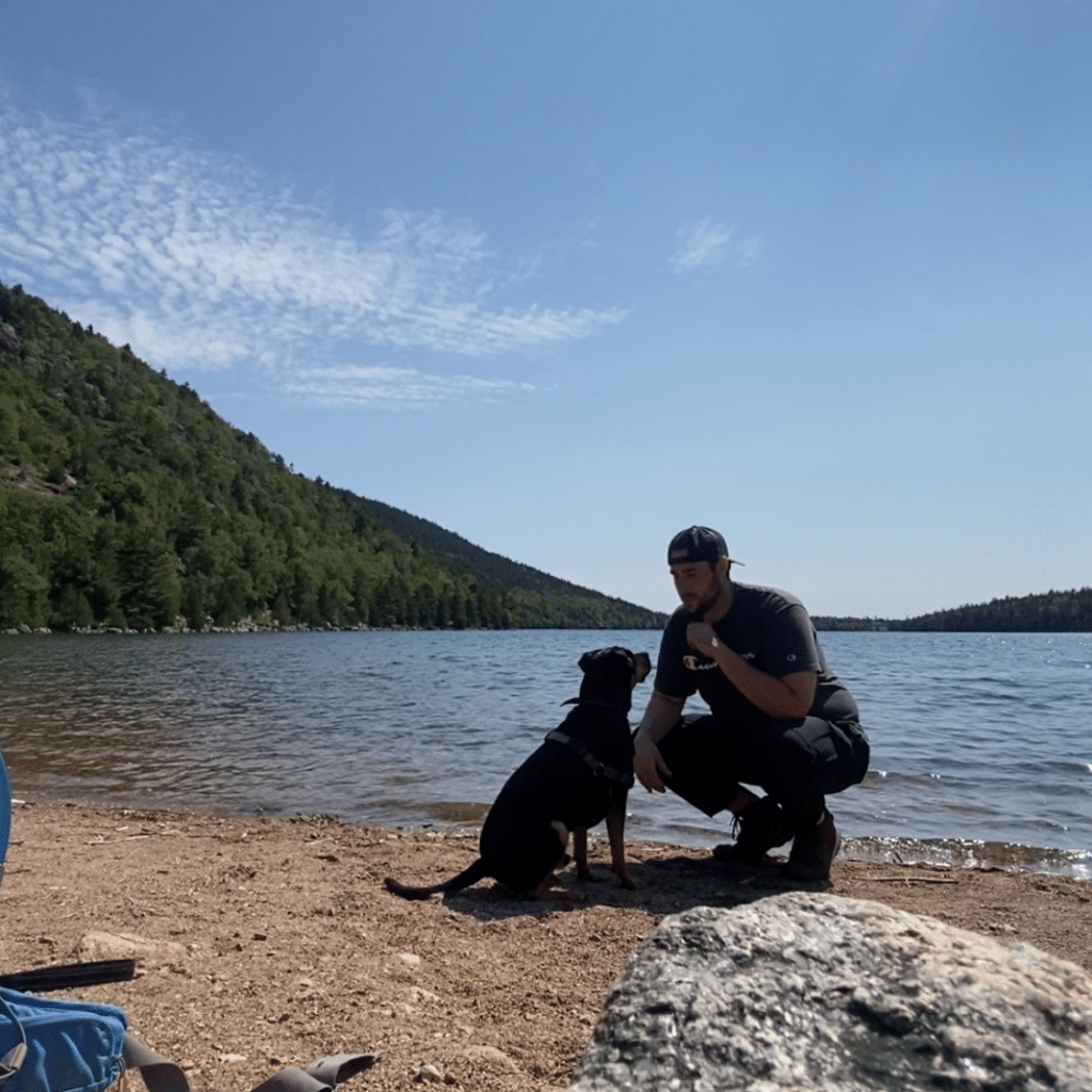 Jason Schwartz with dog by beach