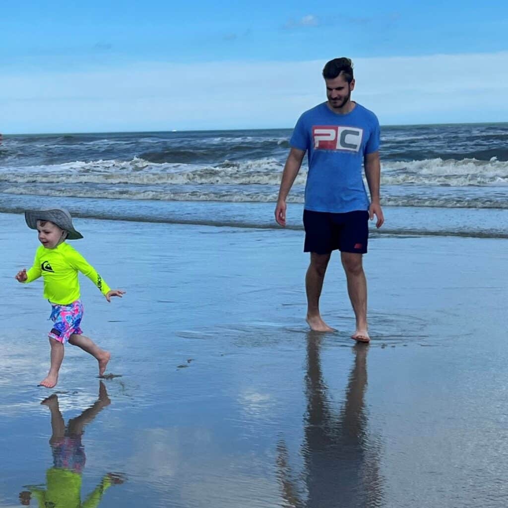 Jeffrey Sabatini on beach with kid