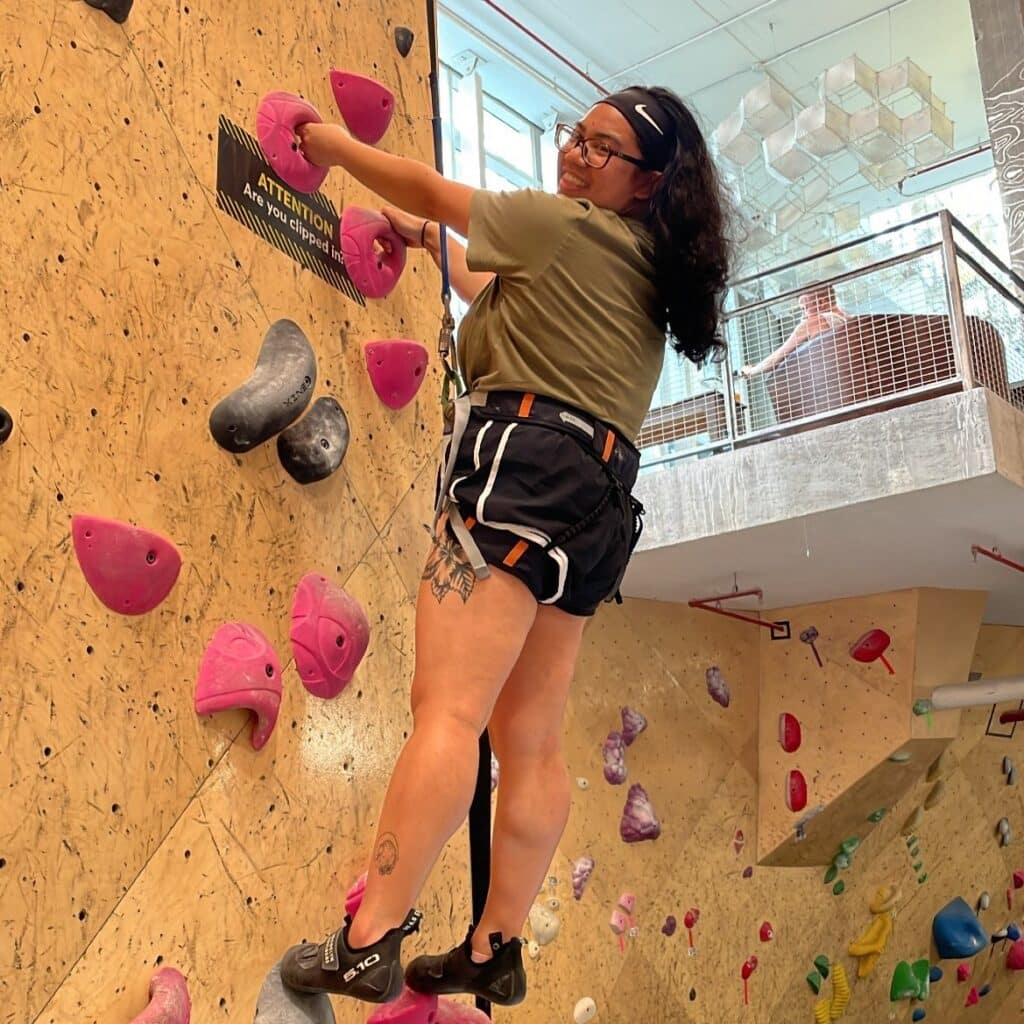 Johanna Sumaria rock climbing in gym