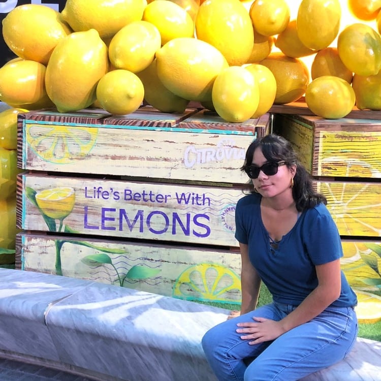 Kathleen Siano in front of a large box of lemons