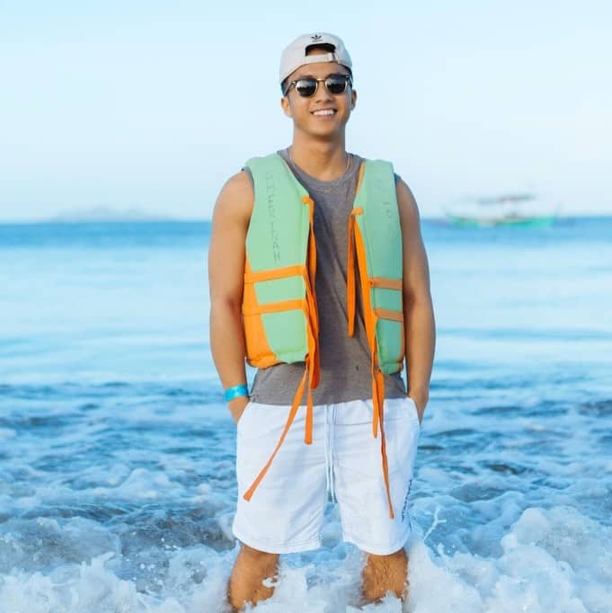 Katie Elifritz with life vest in shorebreak