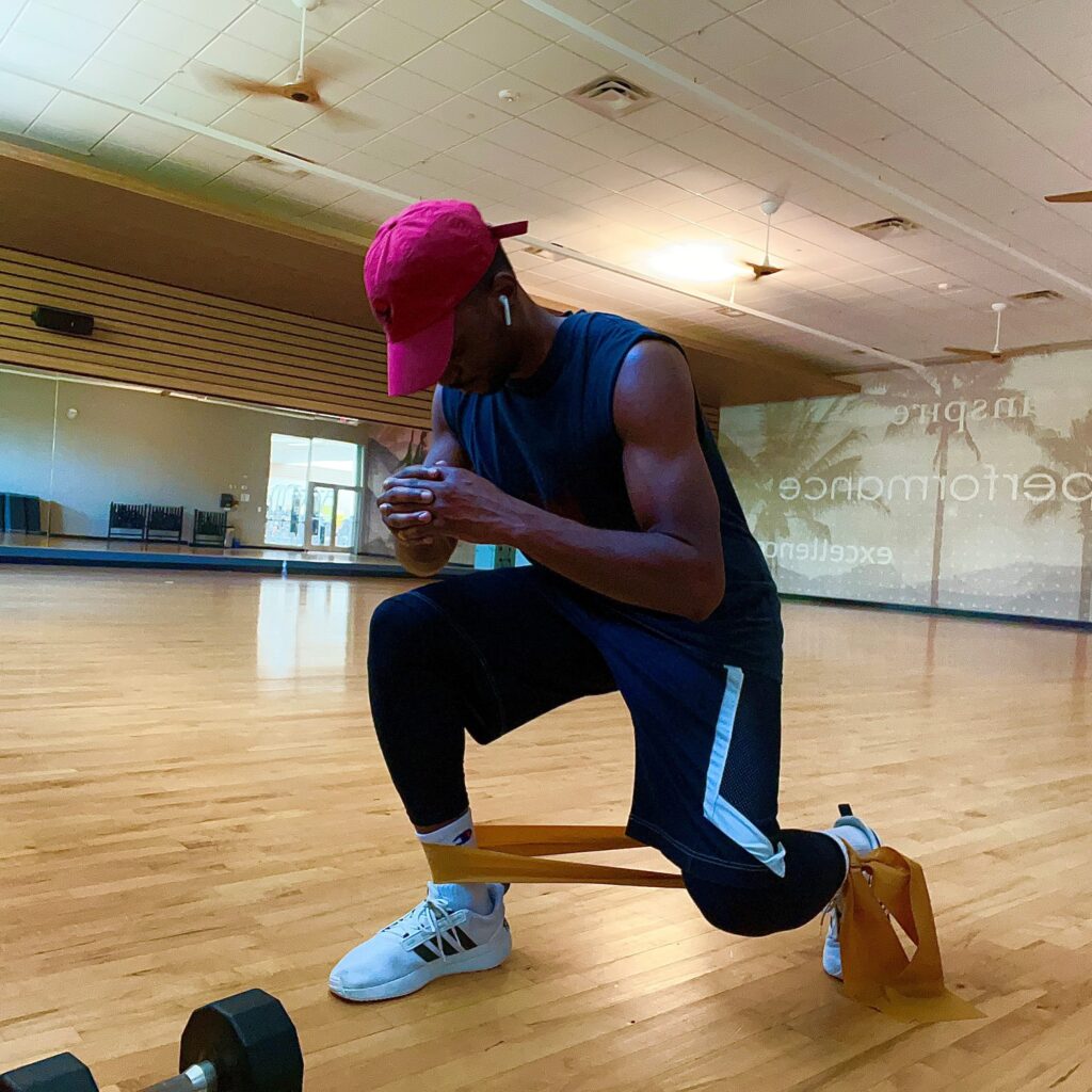 Leke Abiodun exercising with gym bands