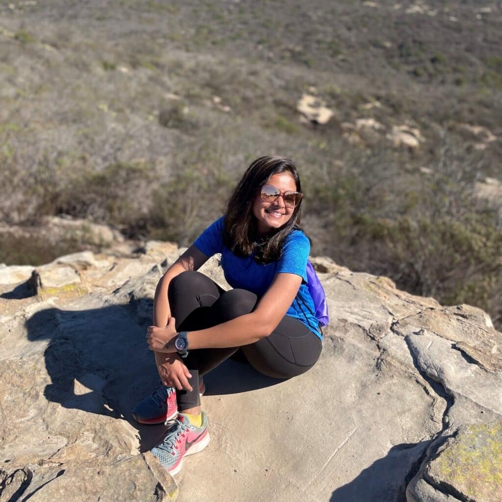 Maitrei Shah sitting on a rock