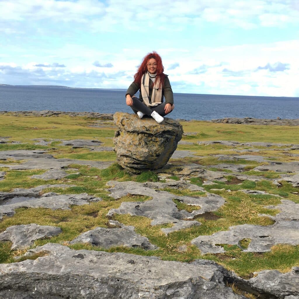 Melissa Brown sitting on rock