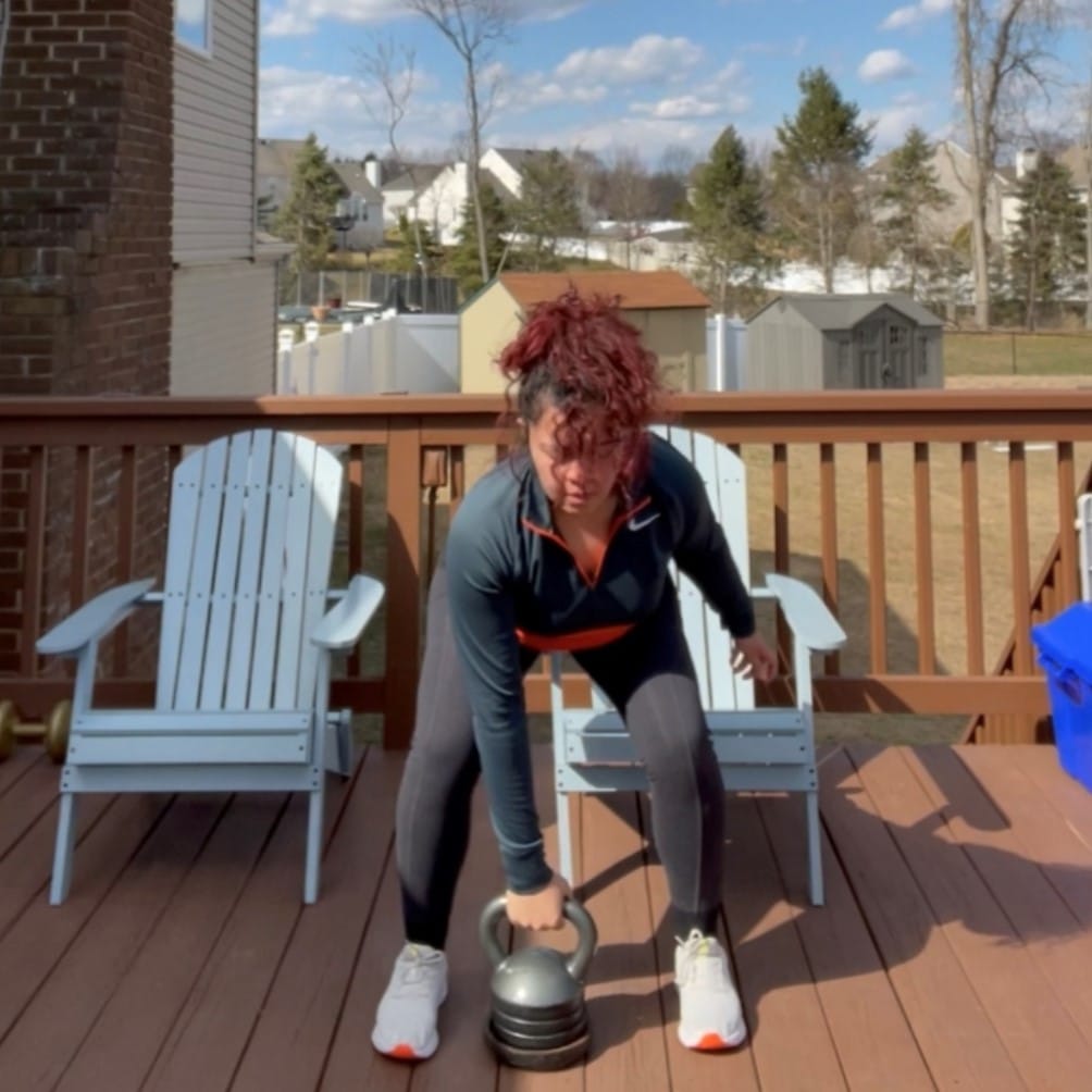 Melissa Brown exercising on porch with dumbells