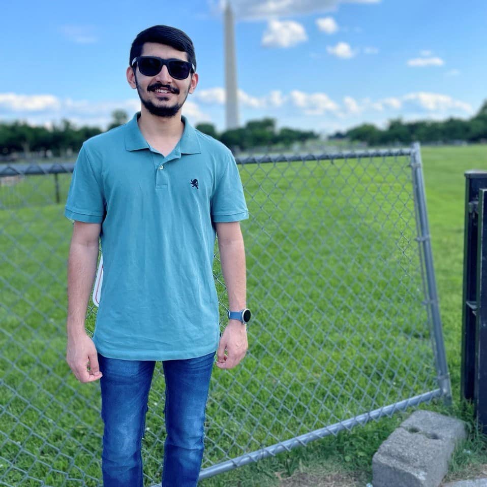 Mohit Vyas in front of metal fence