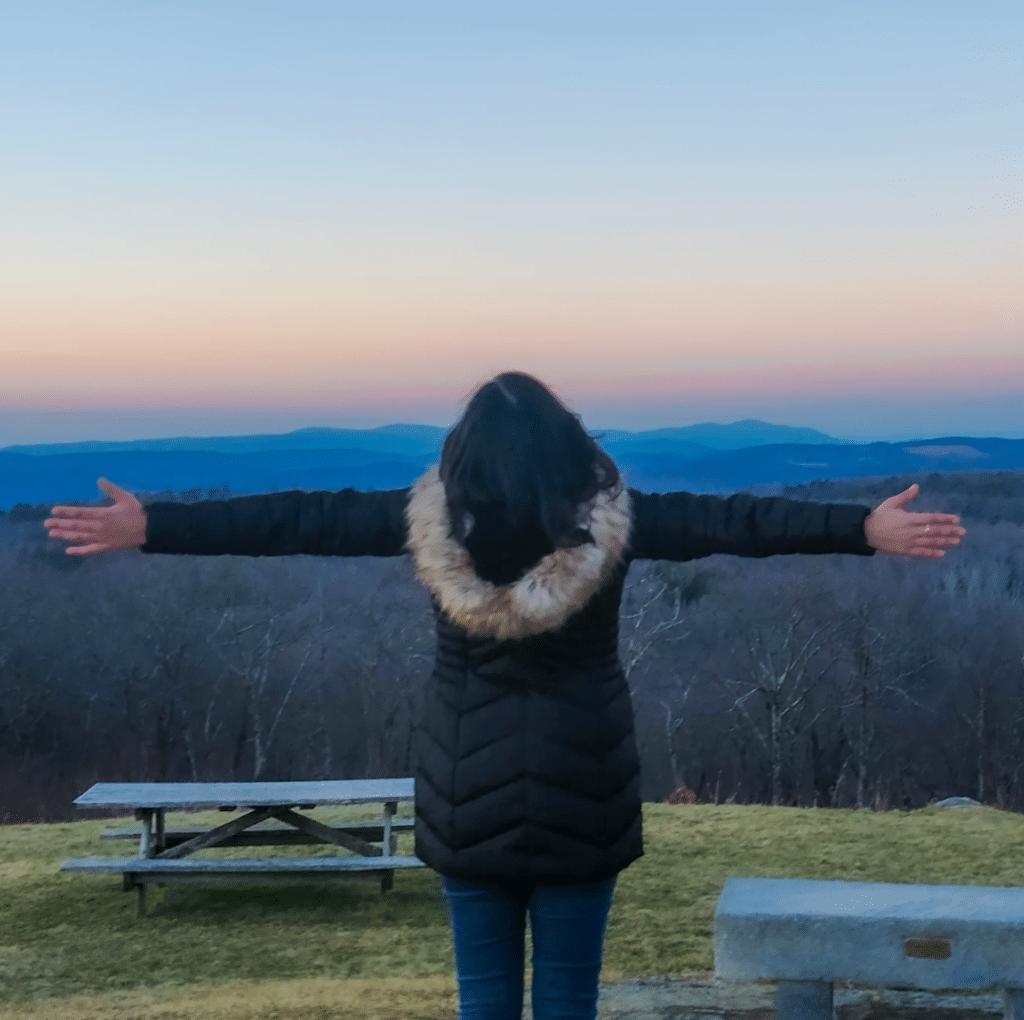 Esha Tiwari on mountain top during sunset