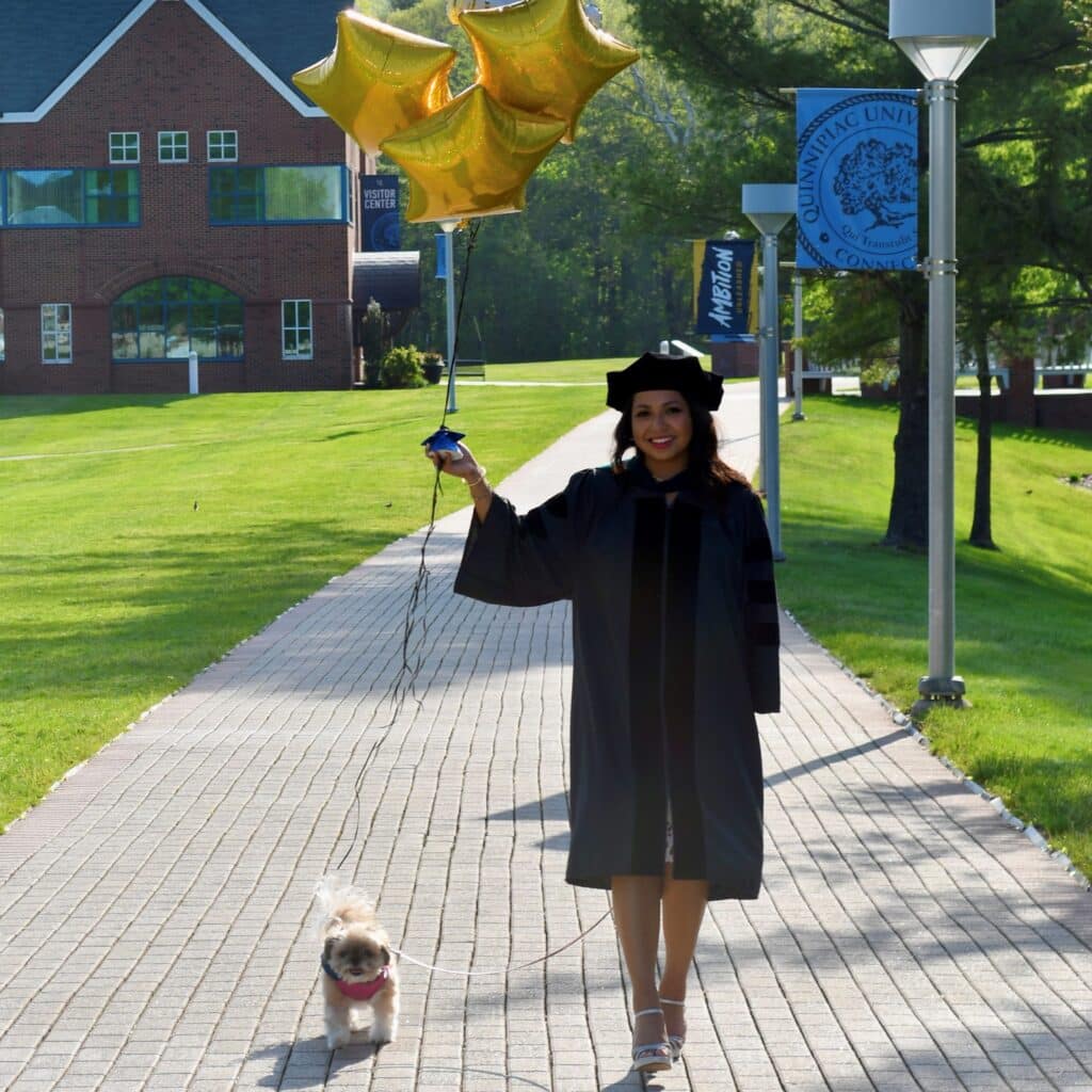 Nicole Mawhirter graduation picture with dog