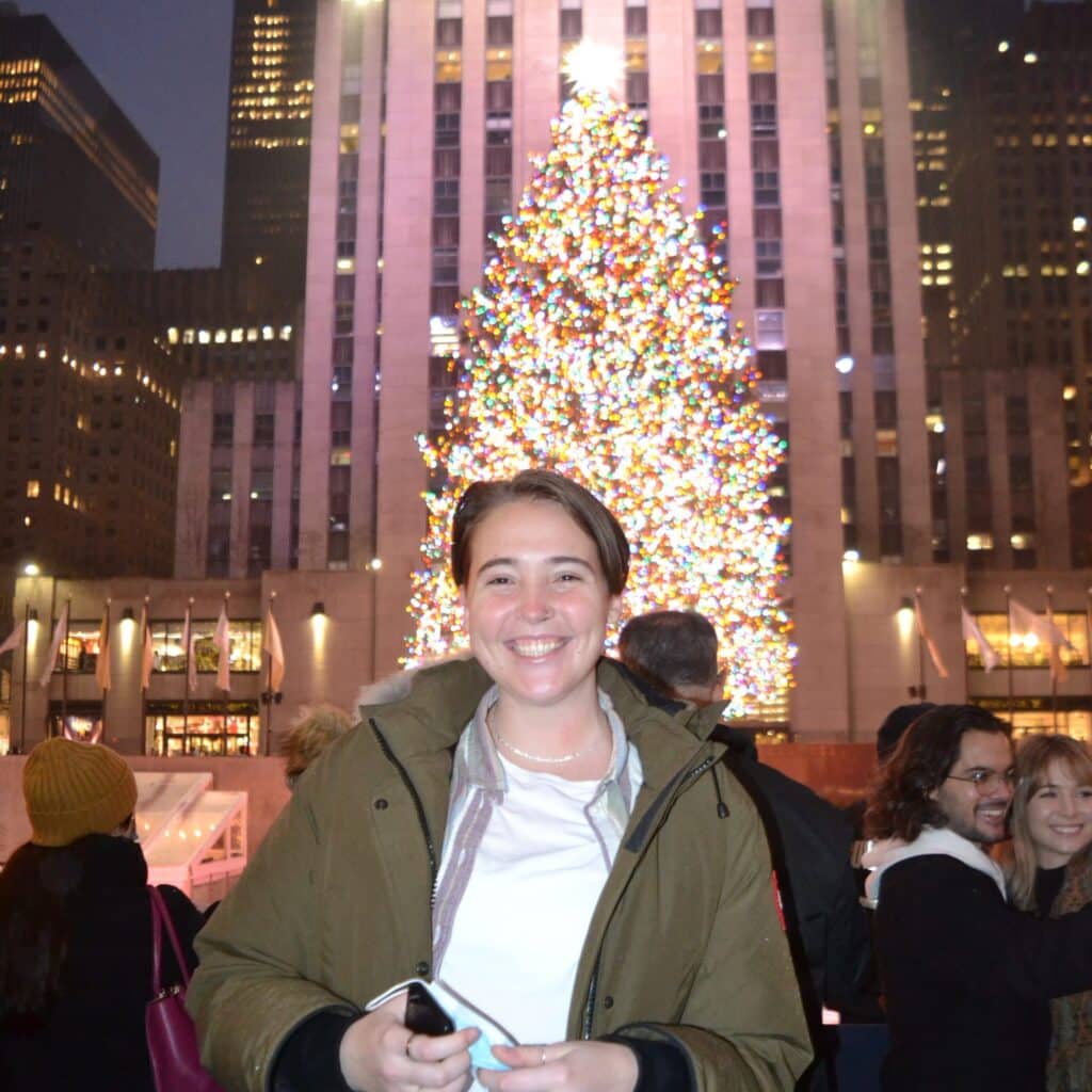 Noelle De Martini in front of Rockefeller Christmas tree