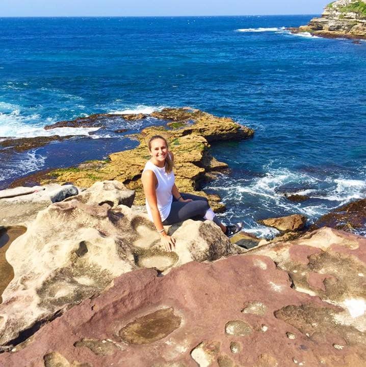 Rachel Klamer travel portrait on rocky beach