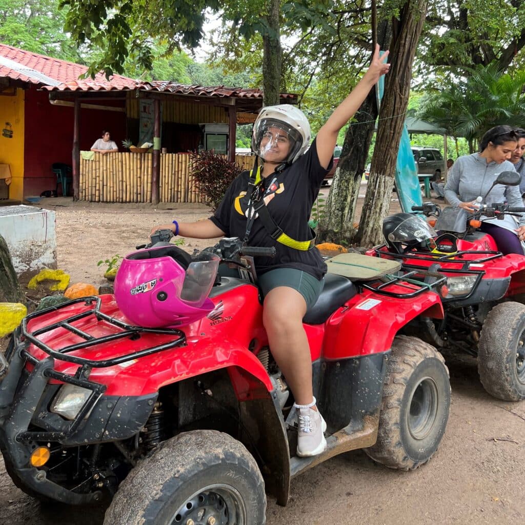 Radhika Patel riding an ATV dirt bike