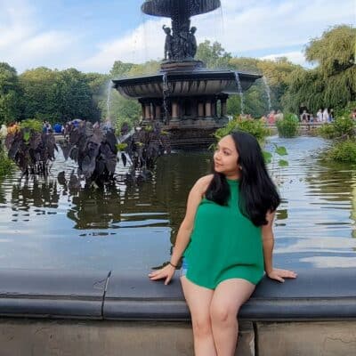 Resham Kadam sitting on a fountain