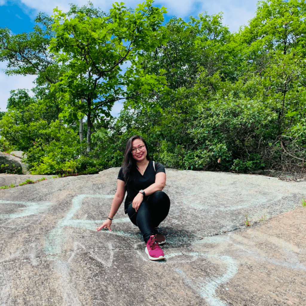 Shevvie Sialana hiking picture sitting on rock