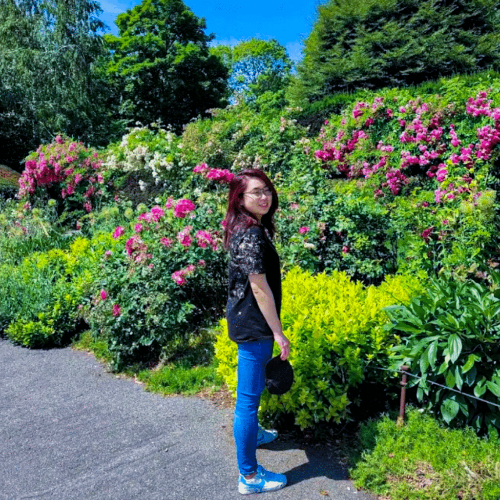 Jia Lin Ou in front of blossoming roses