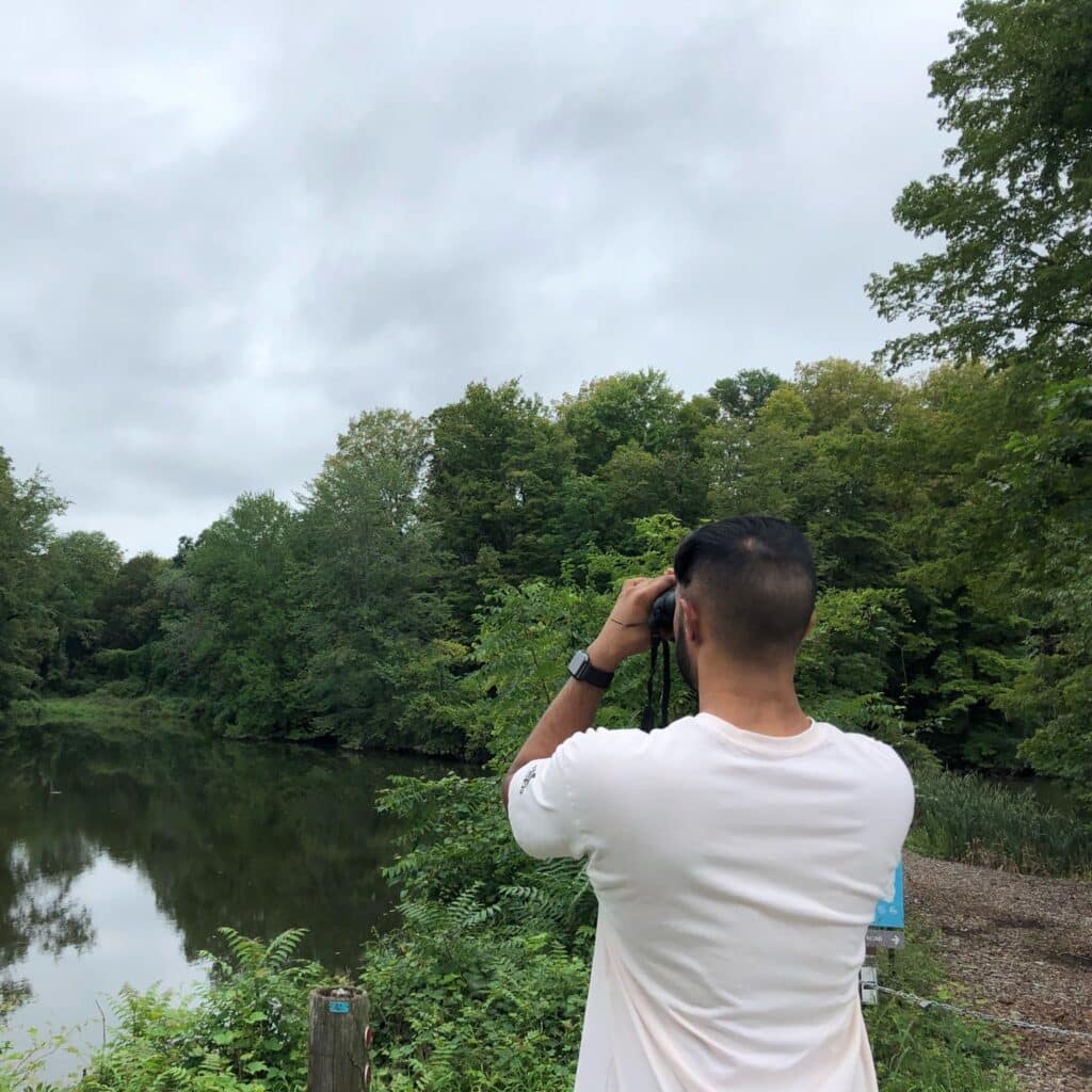 Ryan Bisumber usin binoculars outdoors