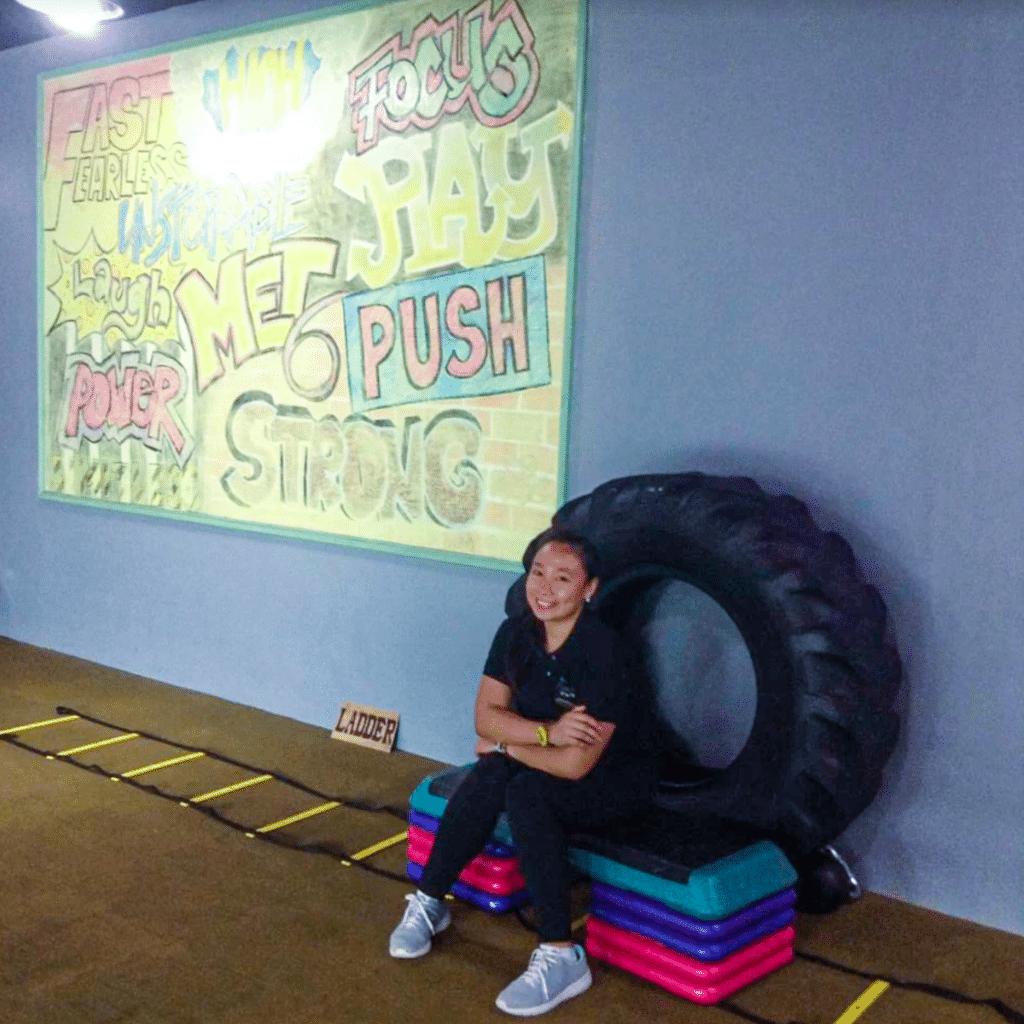 Shevvie Sialana in Gym in front of truck wheel