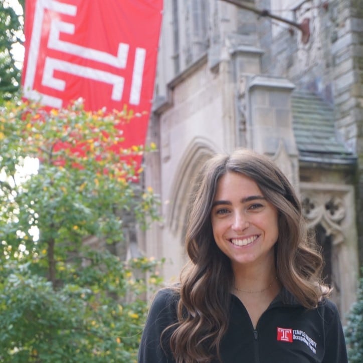 claire grossman in front of a temple flag