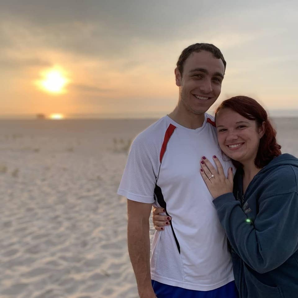 Eric Finkelstein with woman on beach during sunset