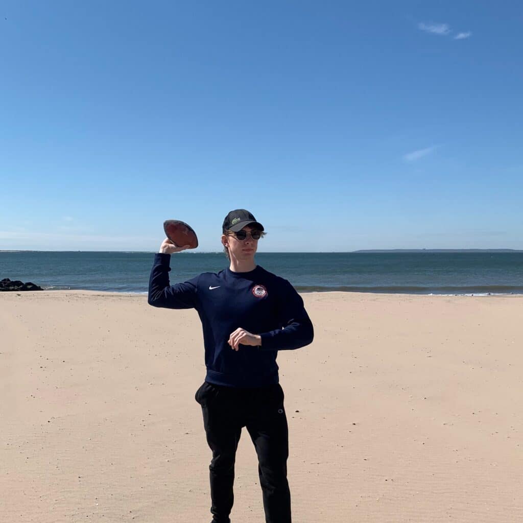 Nicholas Konovalov with football on beach