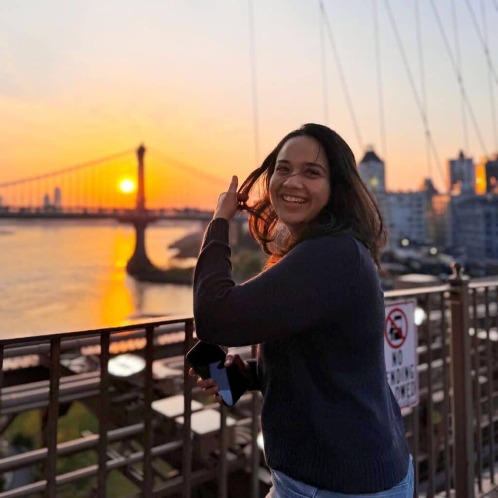 Aashika Shah viewing the sunset overlooking the water