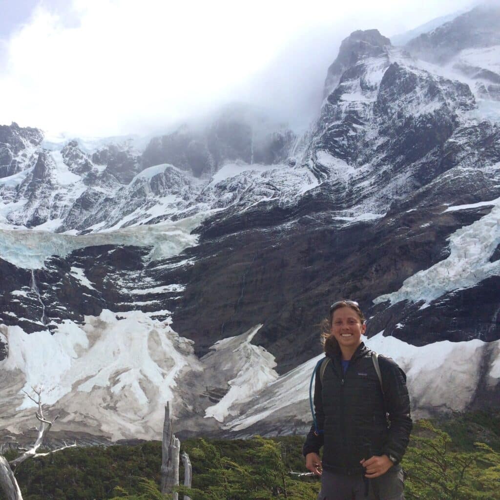 Emily Prader in front of large mountains