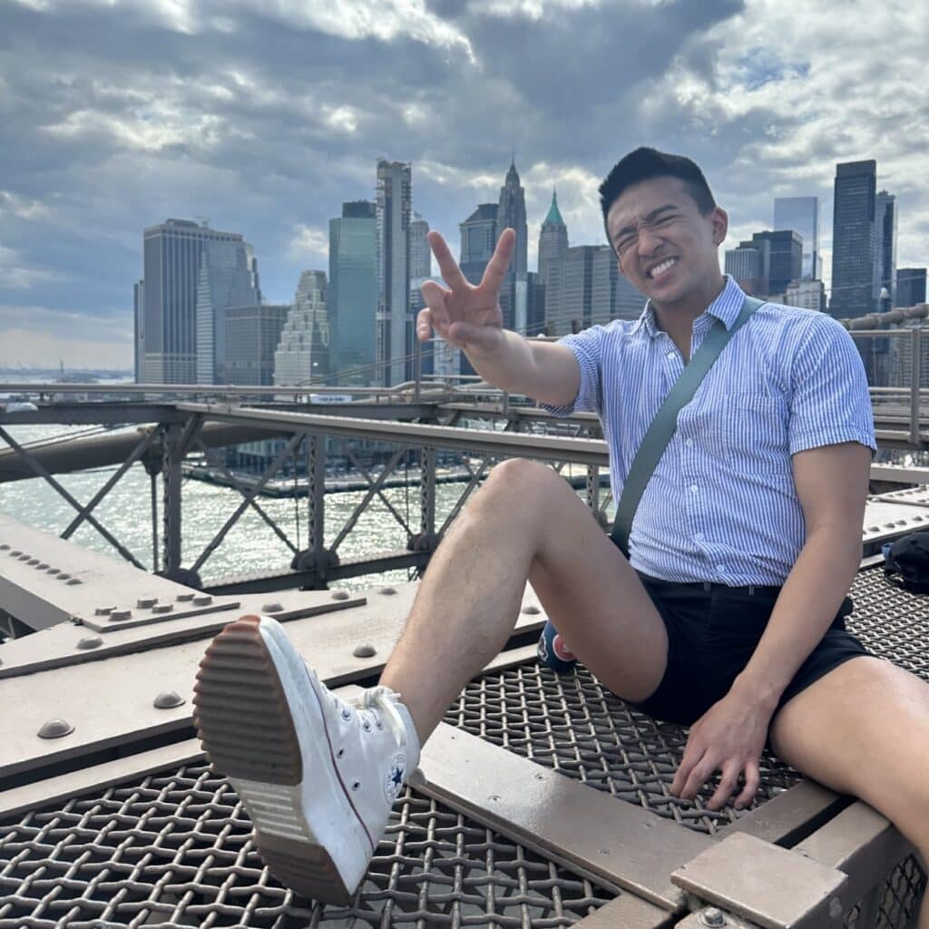 Joren Francisco sitting on a bridge