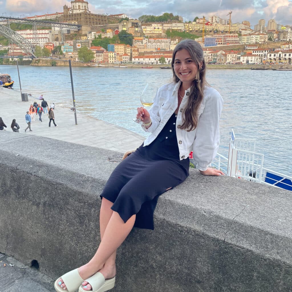 Renna THomas sitting on a sea wall