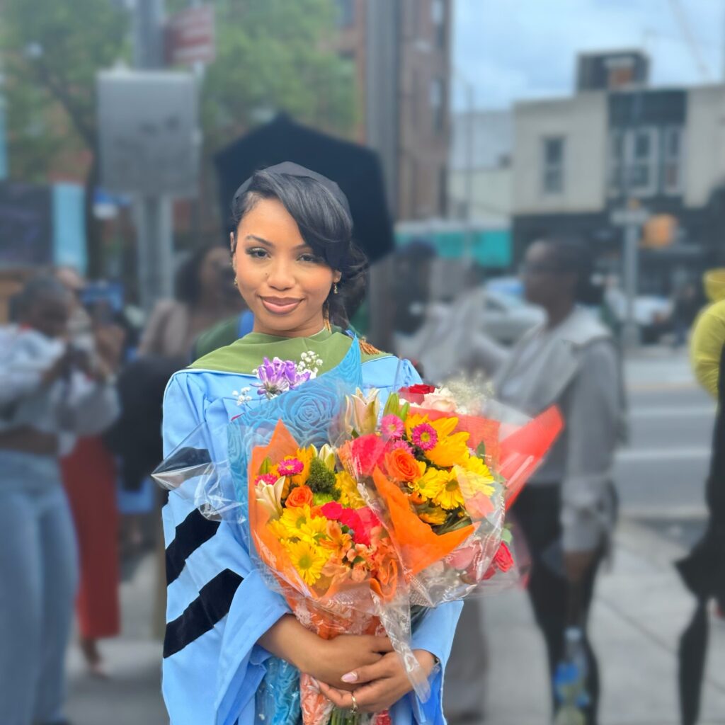 Jada Dubose holding flowers after graduation