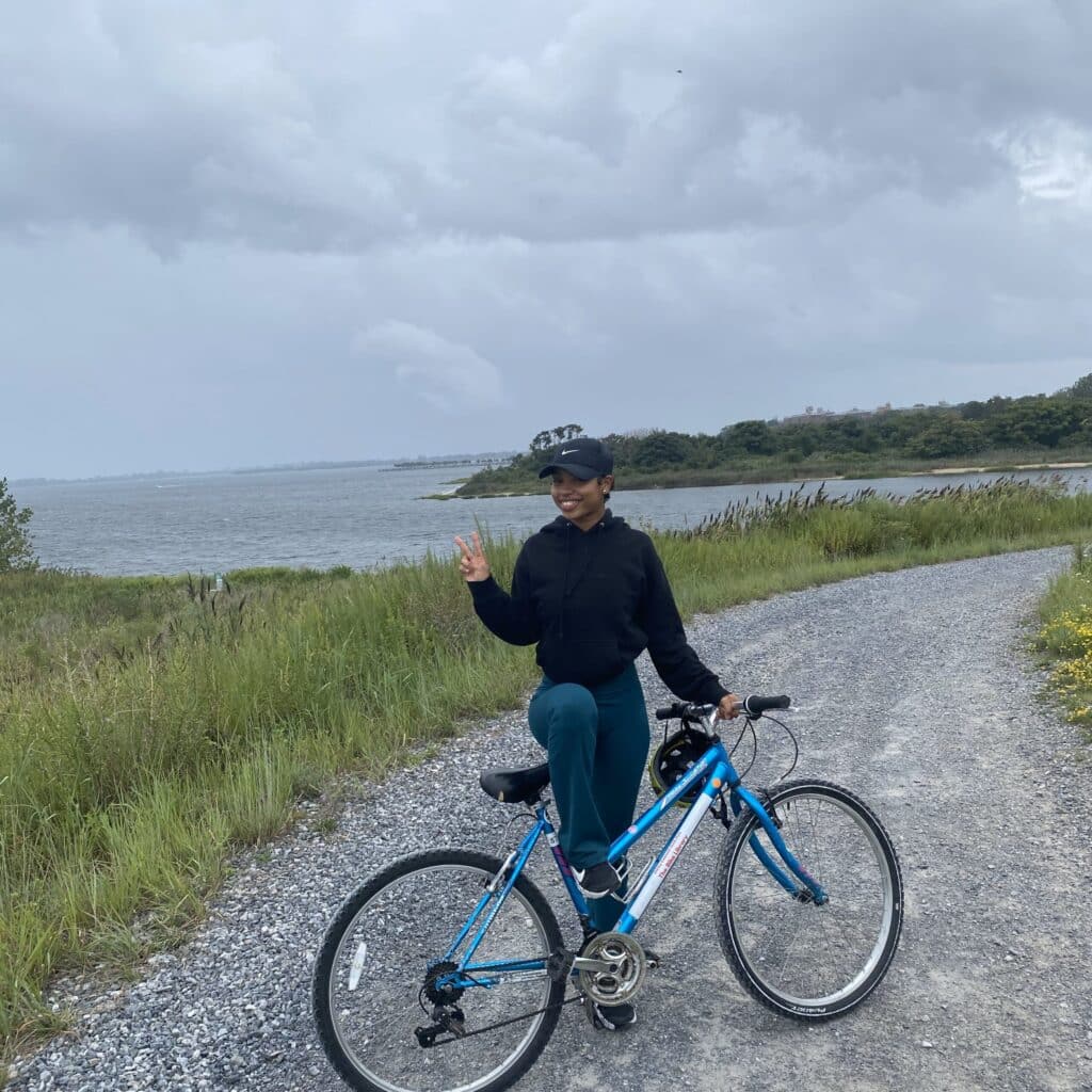 Jada Dubose riding a bike by the water