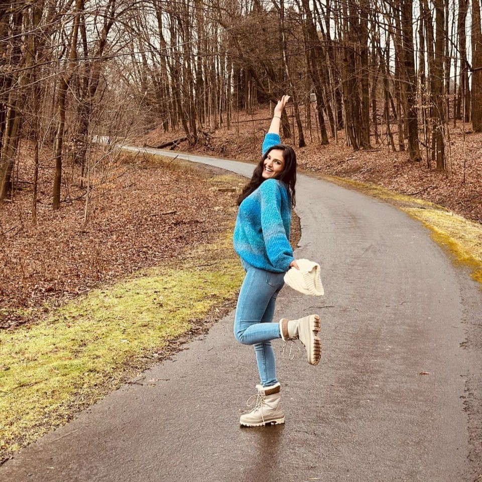 Riddhi Kate walking through the woods