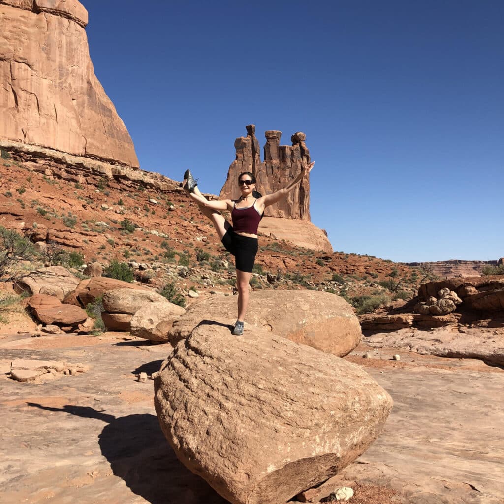 Elisabeth Miller doing yoga on a rock in Utah