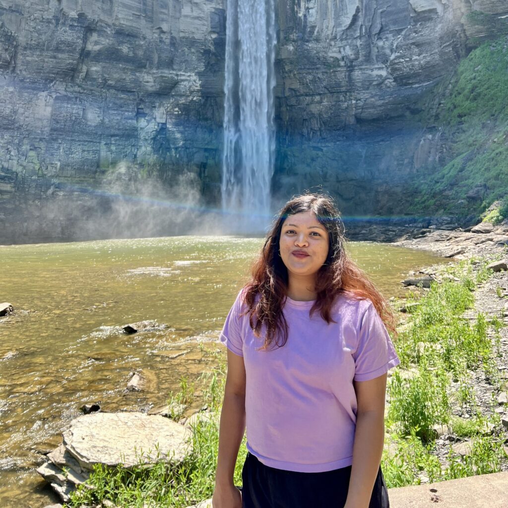 Akshada Manjarekar in front of a waterfall