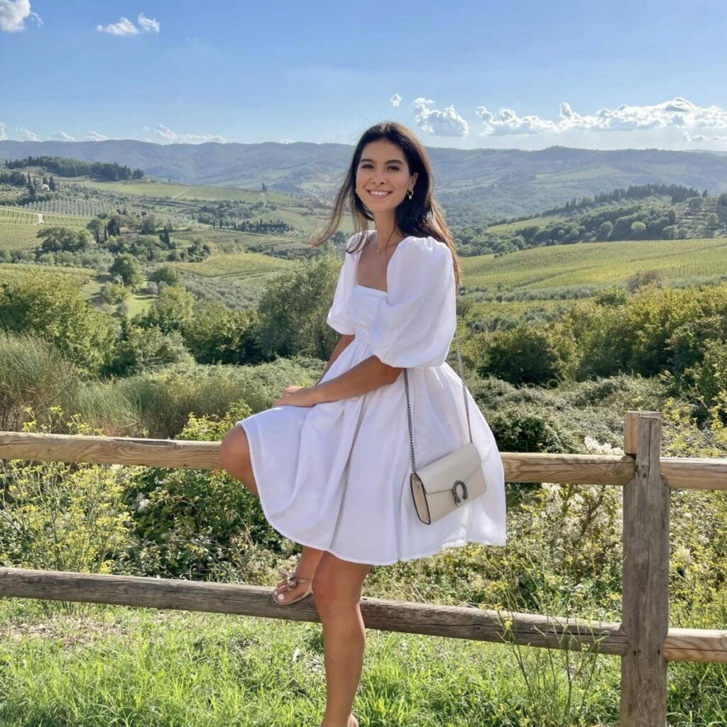 Alexandra D'Annibale sitting on a fence at a farm