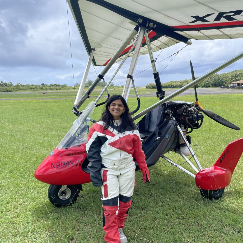 Alpika Jain in front of a stunt airplane