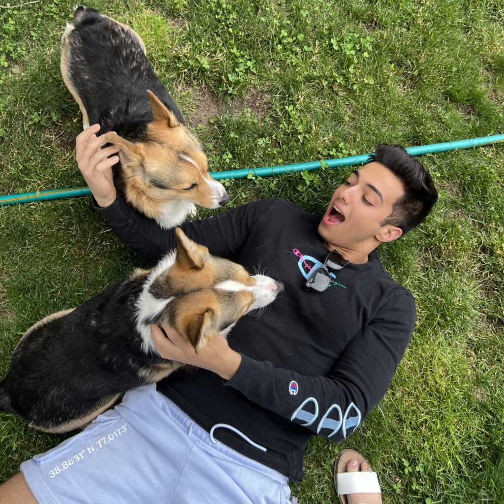 Brandon Barquin playing with puppies outside