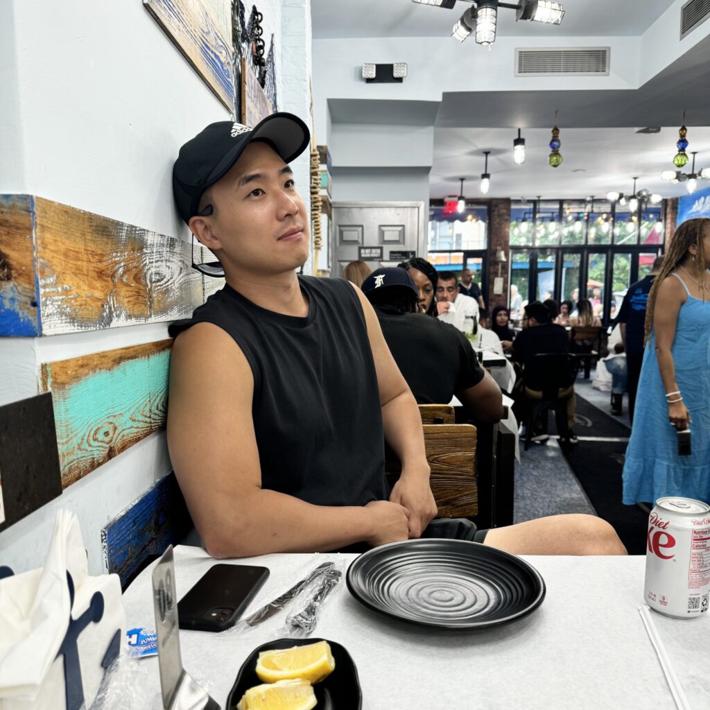 Kyle Kwon at a restaurant table