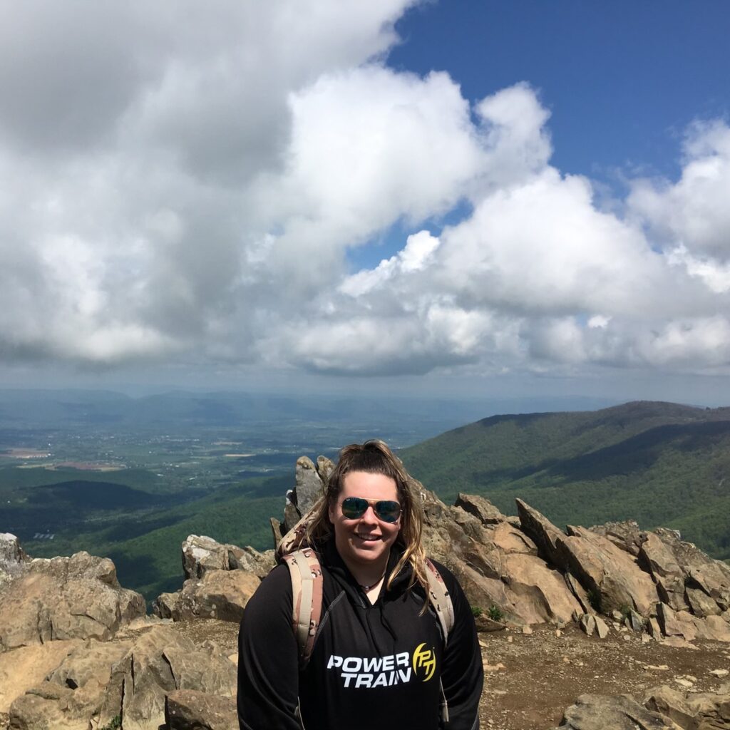 Jacquelyn Albanese hiking a mountain