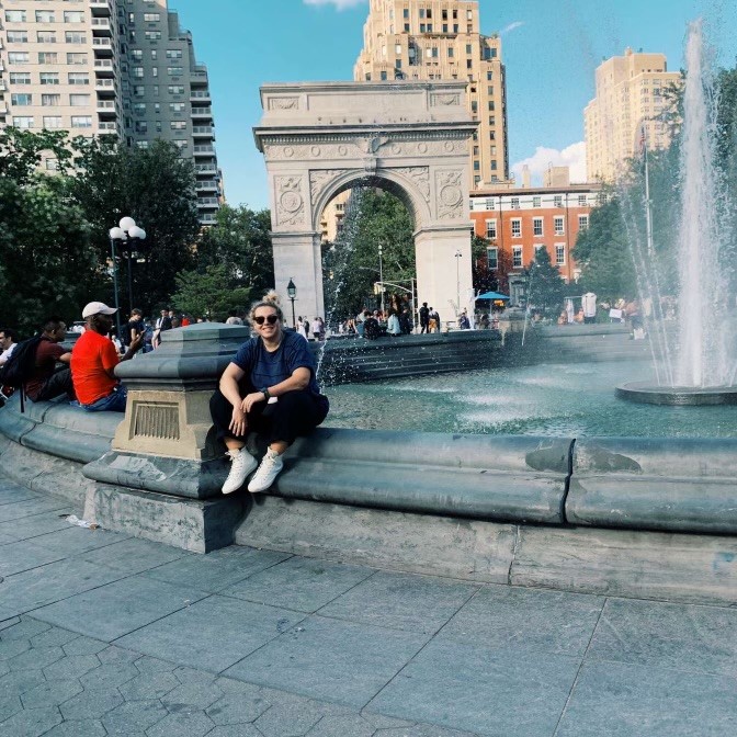 Jacquelyn Albanese sitting on a fountain