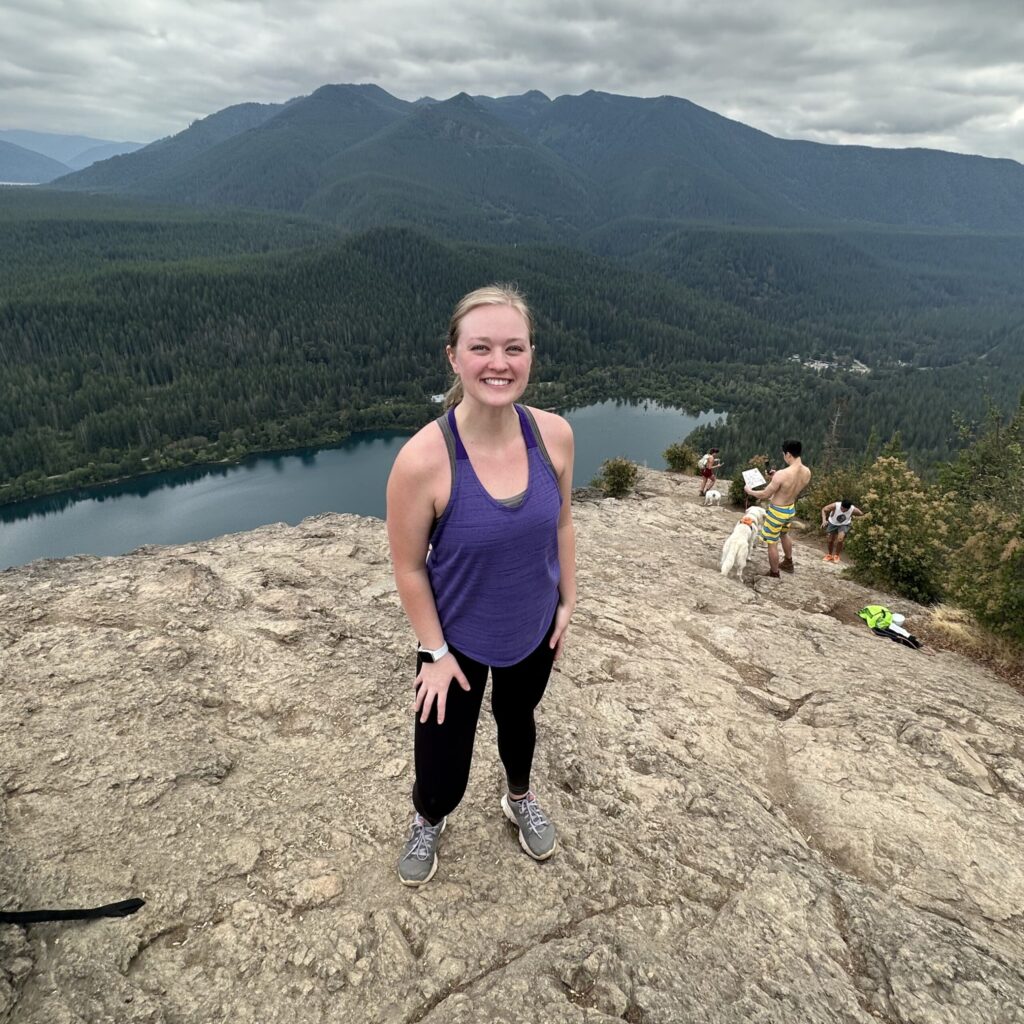 Kristin Seal standing on a rock on a mountain