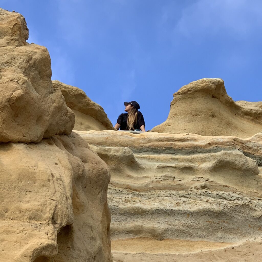 Laura Gonzalez behind a big rock